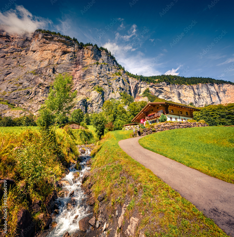 Superb summer view of Lauterbrunnen village with pyre water spring. Beautiful outdoor scene in Swiss Alps, Bernese Oberland in the canton of Bern, Switzerland, Europe. Travel the world. Superb summer view of Lauterbrunnen village with pyre water spring. Beautiful outdoor scene in Swiss Alps, Bernese Oberland in the canton of Bern, Switzerland, Europe. Travel the world.