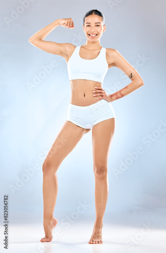 Bicep, fitness and portrait of woman in underwear on studio gray background for health, power or wellness. Arm, exercise and muscle with body of athlete person for goals, satisfaction or strength