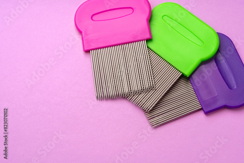 Three combs for removing lice and nits on lilac background photo