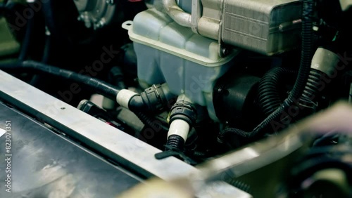 close-up At service station an oil tank with tubes installed in the car photo