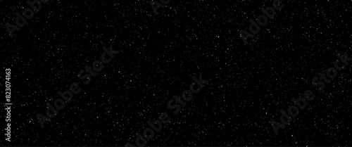 Obraz na płótnie Flying dust particles on a black background, abstract real dust floating over black background for overlay, night sky graphic resources star on snow effect background w salonie