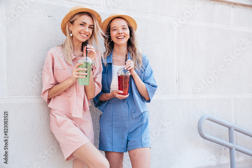 Photography Two young beautiful smiling hipster female in trendy summer clothes