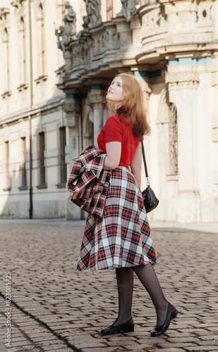 young beautiful woman in vintage suit in european city