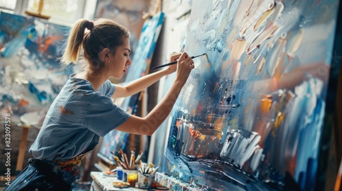 An art student in a studio, working on a large canvas painting