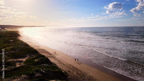 Travellers on sunrise stroll on Lappiesbaai Blue Flag beach in Stilbaai. Aerial photo