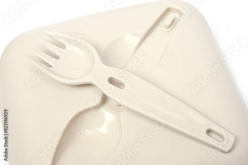 Plastic food container with built-in fork and gravy boat.