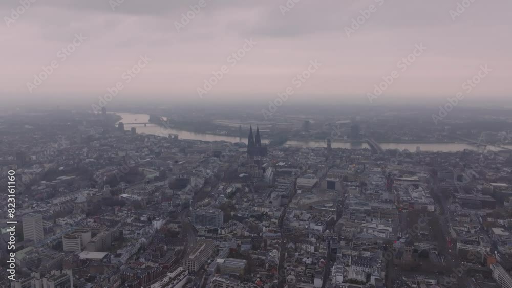 Cologne's cityscape from a drone capturing the architecture and the winding Rhine River on a cloudy day. German metropolis from a high angle perspective Cologne's cityscape from a drone capturing the architecture and the winding Rhine River on a cloudy day. German metropolis from a high angle perspective