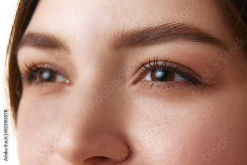 Close-up of woman's eyes, showcasing well-groomed eyebrows, long eyelashes, and clear skin, emphasizing natural beauty and facial detail. Concept of make up, organic cosmetic, facecare, healthcare.