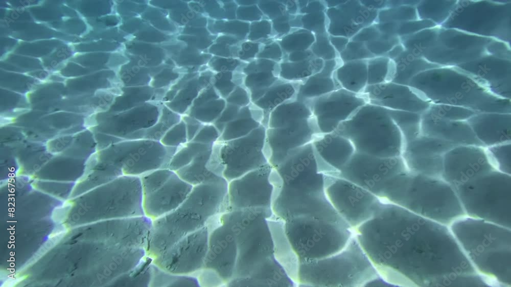 view of an underwater sand and light reflection view of an underwater sand and light reflection