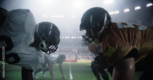 Intense Moments From An American Football Match Played Under Heavy Rain, with Gridiron Players Tackle and Execute Plays. Teams Compete on the Field in a Sports Battle for Tournament Glory photo