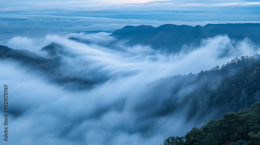 A mystical, foggy morning in the mountains reveals peaks piercing a dense cloud canopy, creating ethereal views.