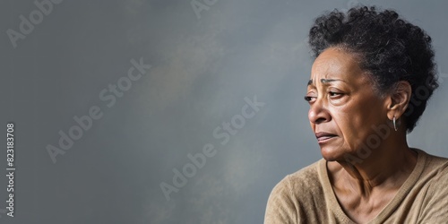 Cream background sad black american independant powerful Woman realistic person portrait of older mid aged person beautiful bad mood expression Isolated on Background racism  photo