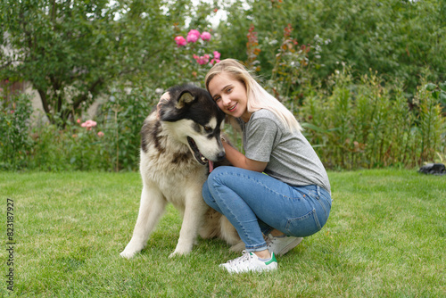 A girl with a malamute dog