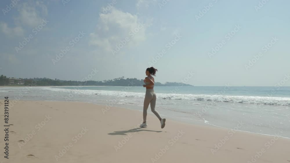 Cinematic Aerial Shot of Female Beach Runner During Outdoor Workout Cinematic Aerial Shot of Female Beach Runner During Outdoor Workout