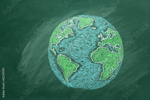 A chalk-drawing of Earth on a green classroom blackboard, showing continents in vibrant colors and surrounded by oceans