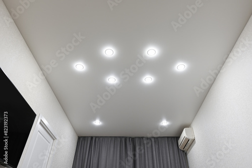 Stretch ceiling in the bedroom with built-in lighting.
