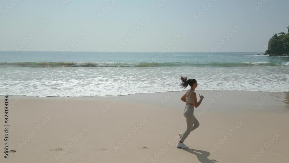 Aerial Drone View of Asian Jogger Woman During Morning Beach Run Aerial Drone View of Asian Jogger Woman During Morning Beach Run