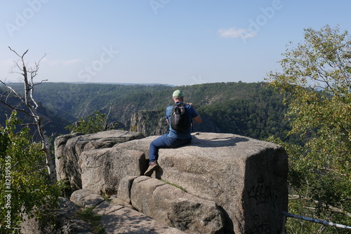 Sitzender Mann über Bodetal im Harz bei Thale photo