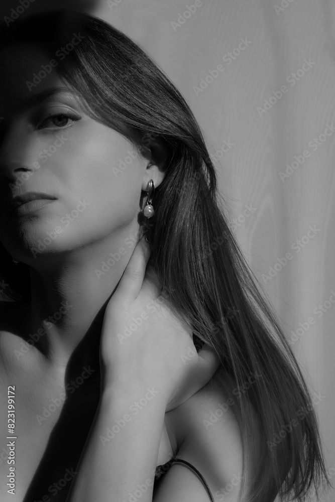 Black and white Portrait of a beautiful young woman with jewelry. Stylish brunette model with natural beauty and long hair. indoor shot.Luxury fashion style portrait of Ukrainian model. Fashion blog. Black and white Portrait of a beautiful young woman with jewelry. Stylish brunette model with natural beauty and long hair. indoor shot.Luxury fashion style portrait of Ukrainian model. Fashion blog.