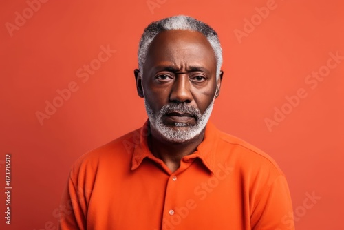 Coral background sad black American independent powerful man. Portrait of older mid-aged person beautiful bad mood expression isolated on background racism skin color depression anxiety fear burnout h © Zickert