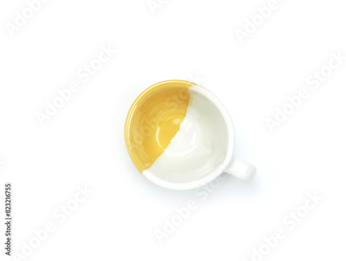 Empty yellow-white mug isolated on white background. Use for home or restaurant, food design. Concept kitchen utensils and tableware. Top view, flat lay..