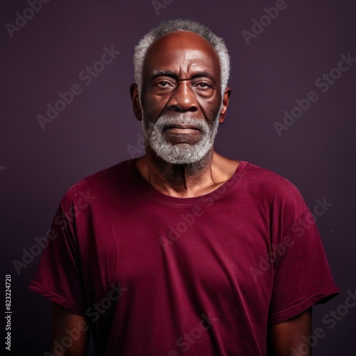 Maroon background sad black American independent powerful man. Portrait of older mid-aged person beautiful bad mood expression isolated on background racism