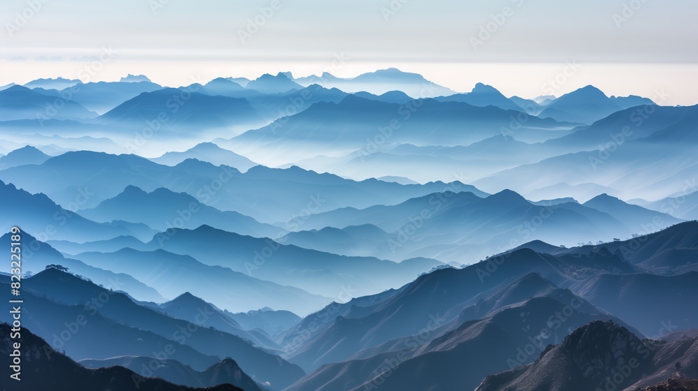 A panoramic view captures mountain ranges fading into mist, creating a breathtaking, ethereal landscape.