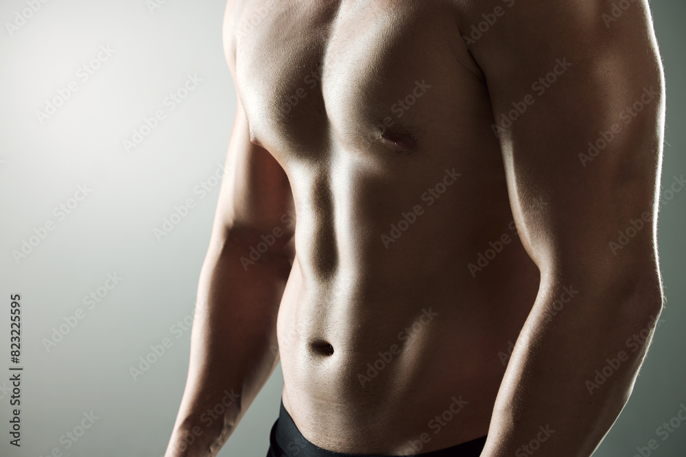 Muscle, strong and body of man for workout, health and exercise for training goal on white studio background. Portrait, sports and bodybuilder model with sexy, young and healthy abs from fitness