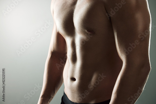 Muscle, strong and body of man for workout, health and exercise for training goal on white studio background. Portrait, sports and bodybuilder model with sexy, young and healthy abs from fitness photo