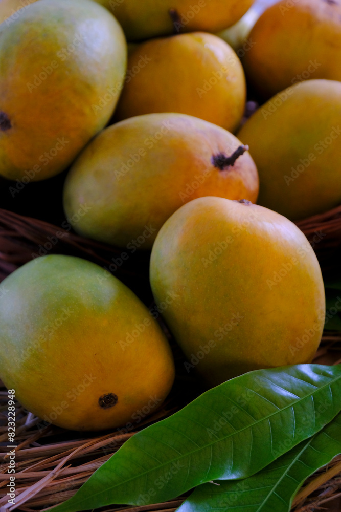 Fresh mango fruit, Mango tropical fruit with green leaf, Ripe mango in grass closeup.