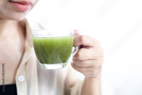 asian woman drinking hot matcha green tea, healthy drink concept