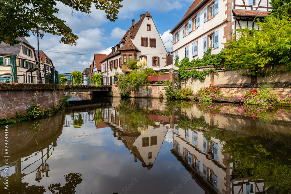 Canal with Reflection in Front of Picturesque Timbered Houses in the Old Town Wissembourg, France, Europe