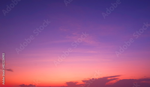 Colorful twilight sky background with beautiful pink and orange cloud on idyllic blue evening sky, romantic sunset sky backdrop