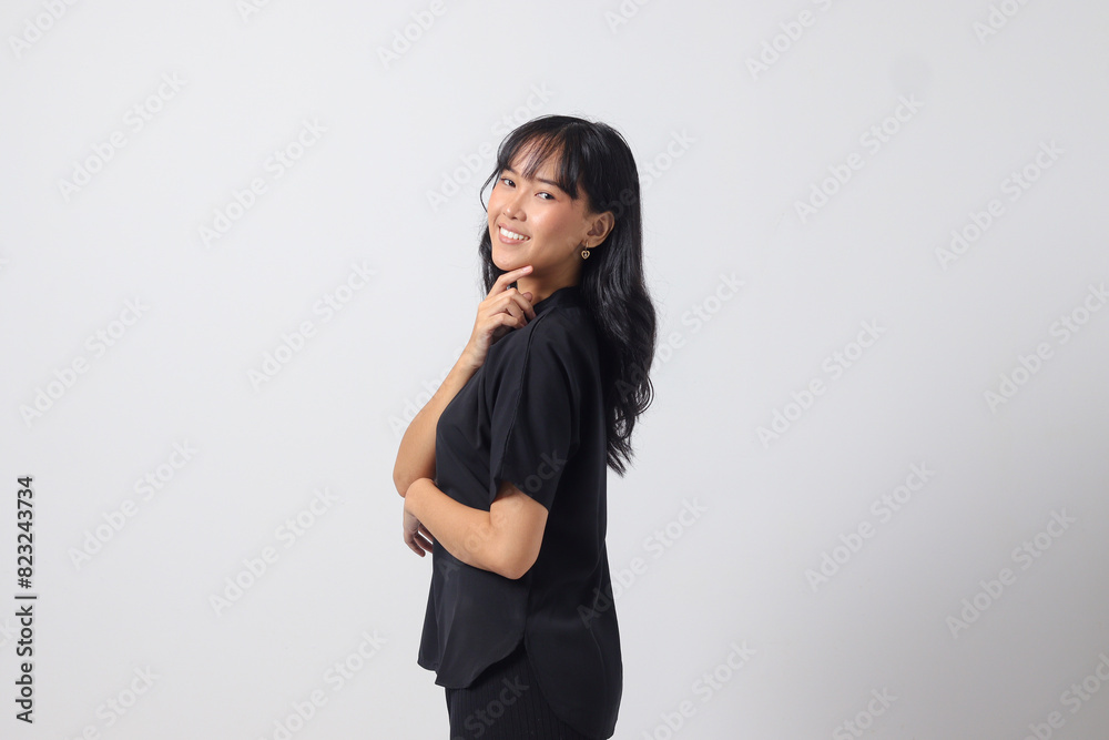 Portrait of attractive Asian woman in casual shirt feeling confident, posing with professional hand gesture. Isolated on white background Portrait of attractive Asian woman in casual shirt feeling confident, posing with professional hand gesture. Isolated on white background