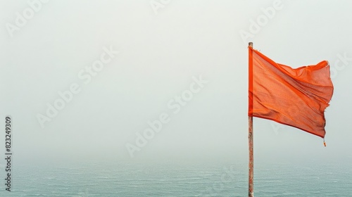 Orange Flag Fluttering in the Wind on Foggy Day