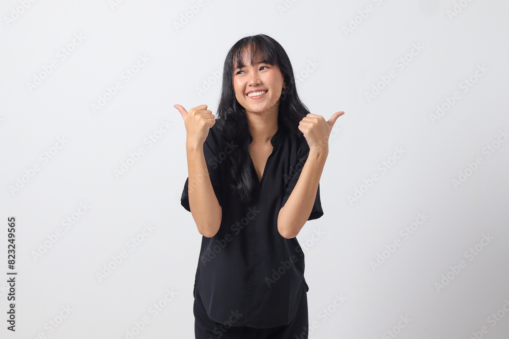 Portrait of attractive Asian woman in casual shirt making thumb up hand gesture, saying good job. Businesswoman concept. Isolated image on white background Portrait of attractive Asian woman in casual shirt making thumb up hand gesture, saying good job. Businesswoman concept. Isolated image on white background