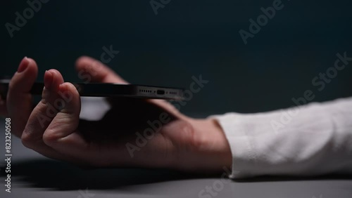 Close-up hand of unrecognizable woman unplugging type-c cable from mobile phone after charge. EU law to force USB-C chargers. Closeup female hand disconnect cable to smartphone, slow motion. photo