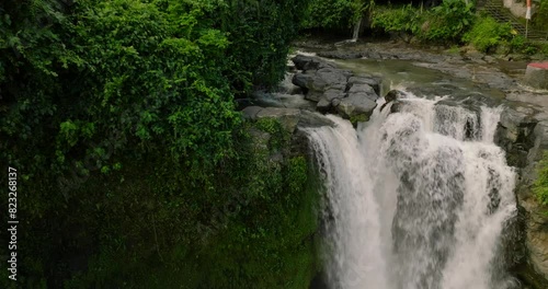 Blangsinga waterfall, Bali. Aerial view of a lush waterfall in a forest photo