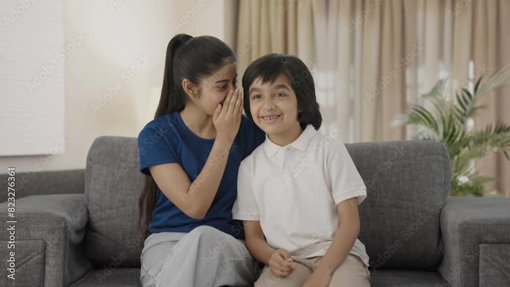 Indian sister telling a secret to her brother Indian sister telling a secret to her brother