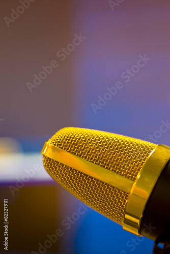 Extreme close up of a gold microphone
