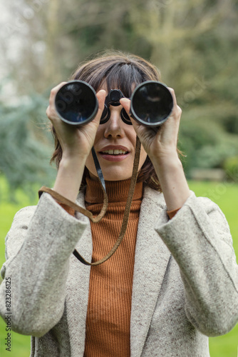 Woman in Park Looking through Binoculars
