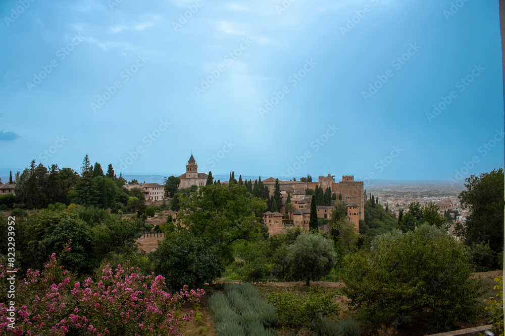 views of the alhambra from the green gardens of the generalife with a clear blue sky views of the alhambra from the green gardens of the generalife with a clear blue sky