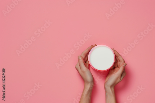 Woman hands holding cream product Cosmetic branding mockup Daily skincare and body care routine Copy space 