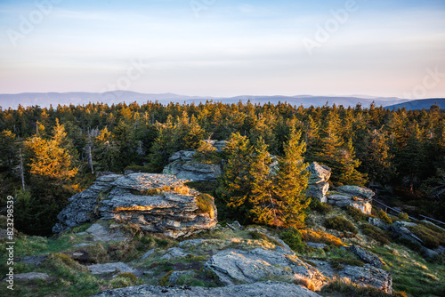 View from mountain summit known as Vozka in natural parkland Jeseniky mountains, Czech Republic. Sunrise in nature. Rock formation in forest and hills photo
