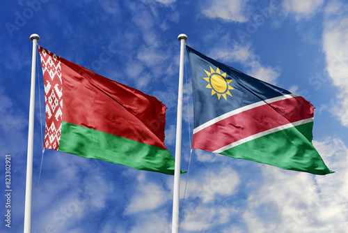 3d illustration. Belarus and Namibia Flag waving in sky. High detailed waving flag. 3D render. Waving in sky. Flags fluttered in the cloudy sky.