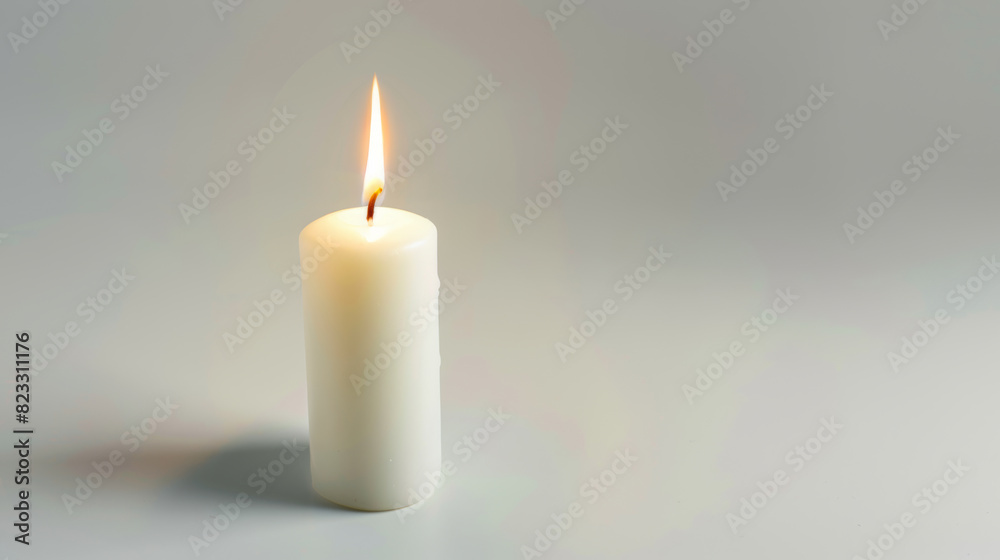 Single white candle burning brightly against a minimalist backdrop. Single white candle burning brightly against a minimalist backdrop.