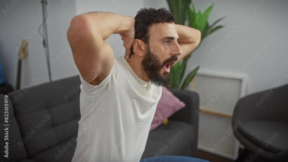 Scared middle age man at home wearing a white t-shirt, hands clutched to his head, mouth agape from the shock. crazy, surprised look of fear! Scared middle age man at home wearing a white t-shirt, hands clutched to his head, mouth agape from the shock. crazy, surprised look of fear!