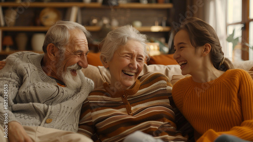 Wallpaper Mural An elderly man with a beard and an elderly woman in a striped cardigan laugh with a young woman in an orange sweater on a cozy couch Torontodigital.ca
