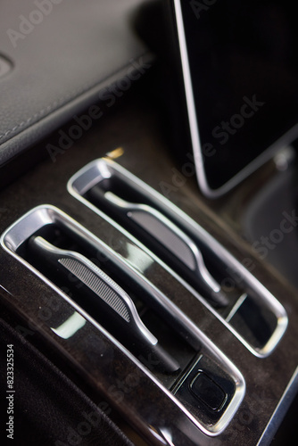 Closeup of car dashboard air vents near gear shift