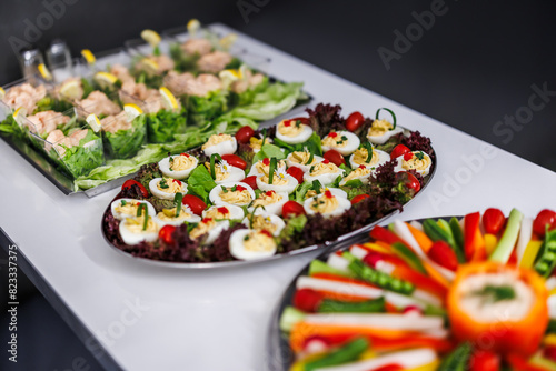 Colorful appetizer platters featuring deviled eggs and fresh vegetables © encierro